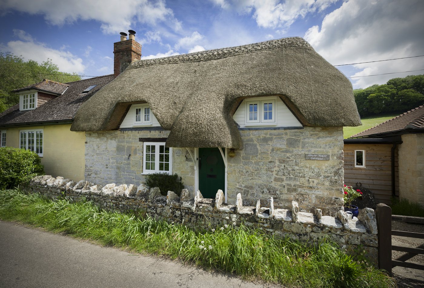 Residence 9 flush windows on a thatched stone cottage