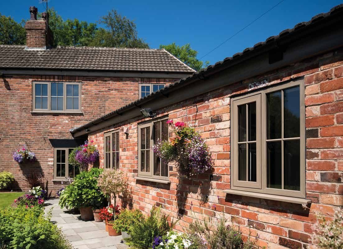 Eurocell Modus flush sash windows on a brick home from the official Modus brochure